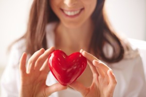 close-up-of-woman-holding-a-bright-heart_1098-2725-300x200